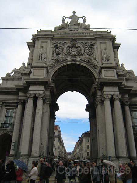 IMG_4481.JPG - The arch over looking the main public square on the former harbour. It's been the scene of many events in Lisbon's history, including the assassination of the penultimate king. There was a nice photo display of the square through the decades, I guess since the square itself was being renovated.